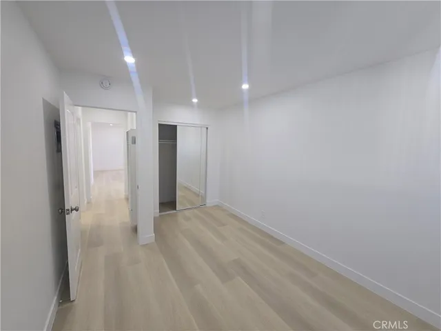 a view of a big room with closet and wooden floor