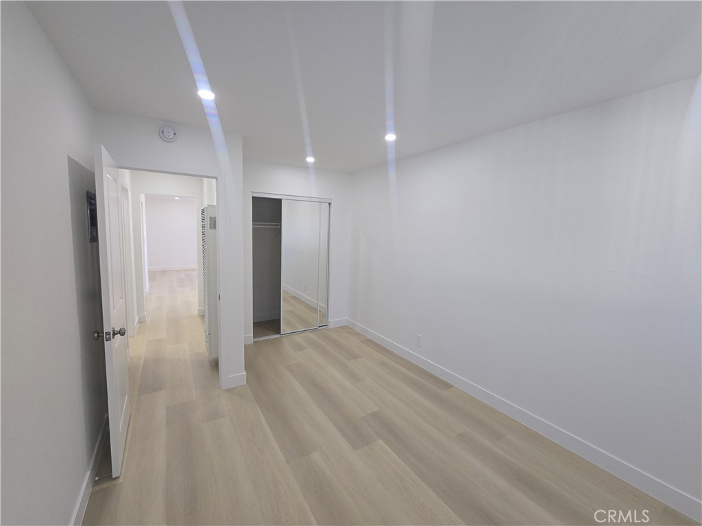 219 15th Street, Unit 12 Huntington Beach, CA 92648 - Photo 13 of 16 a view of a big room with closet and wooden floor