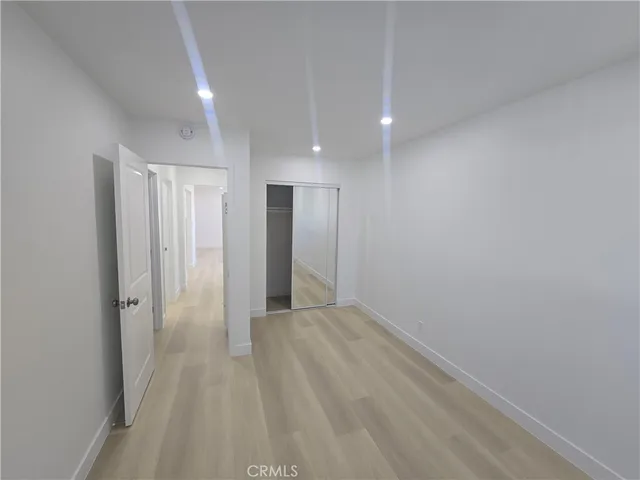 a view of a hallway with wooden shelves