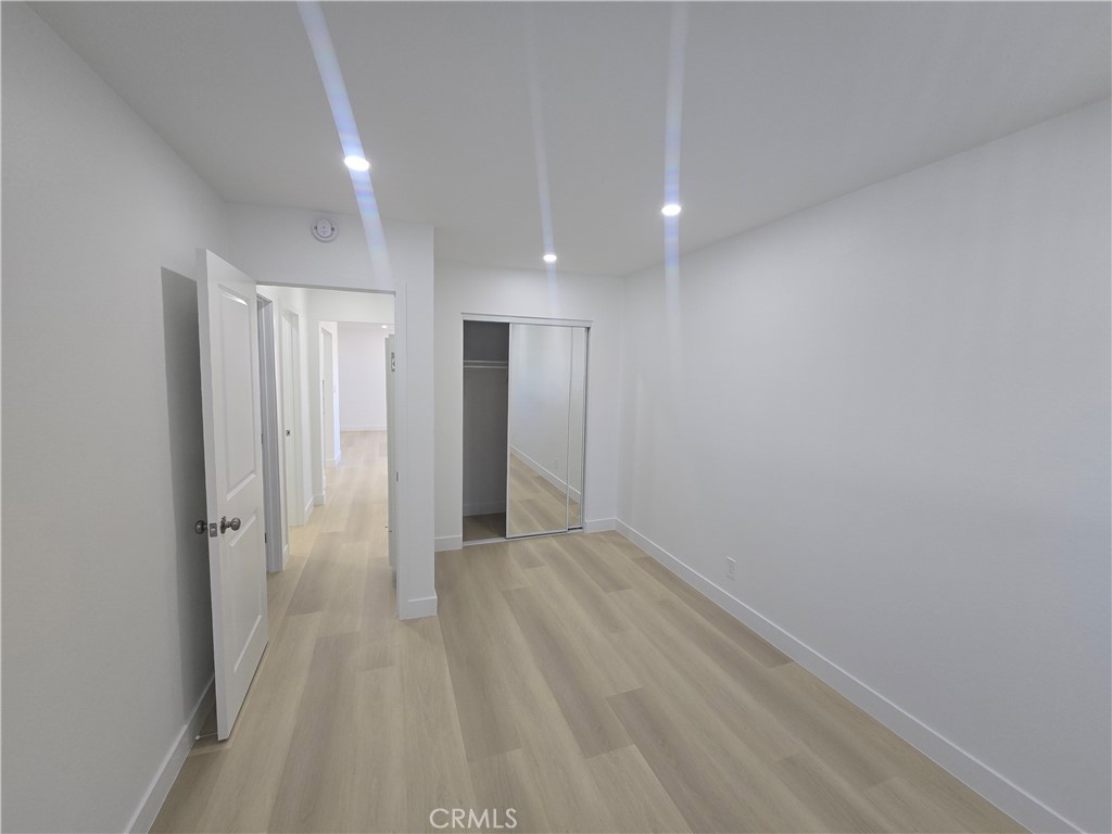 219 15th Street, Unit 12 Huntington Beach, CA 92648 - Photo 14 of 16 a view of a hallway with wooden shelves