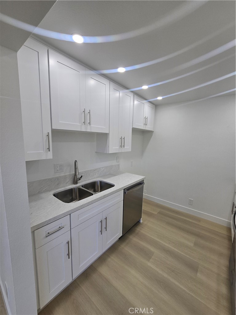 219 15th Street, Unit 12 Huntington Beach, CA 92648 - Photo 5 of 16 a kitchen with a sink and cabinets