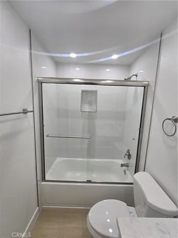 a bathroom with a shower and a toilet