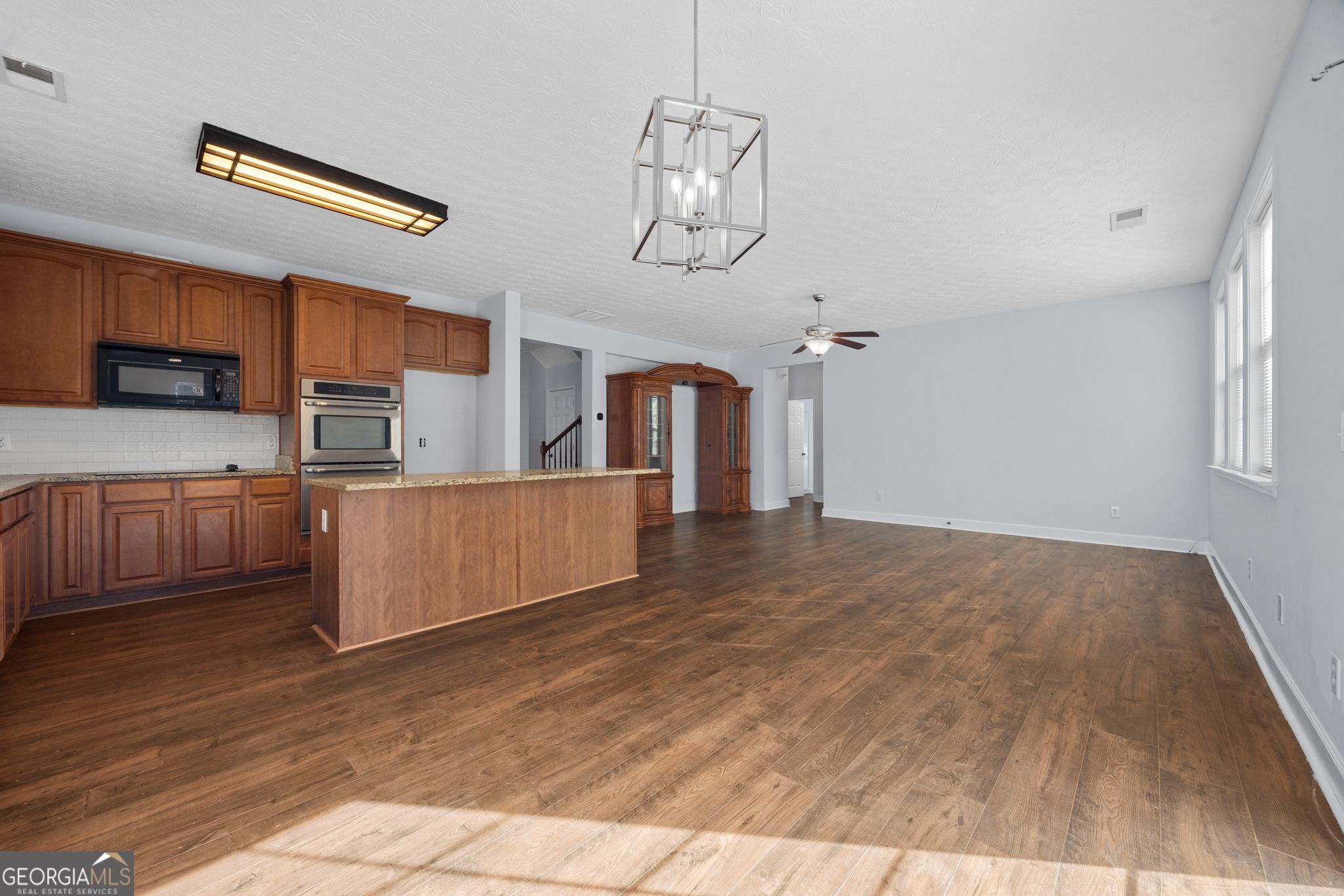 35 Timber Lane Newnan, GA 30265 - Photo 11 of 51 a view of a kitchen with cabinets and wooden floor