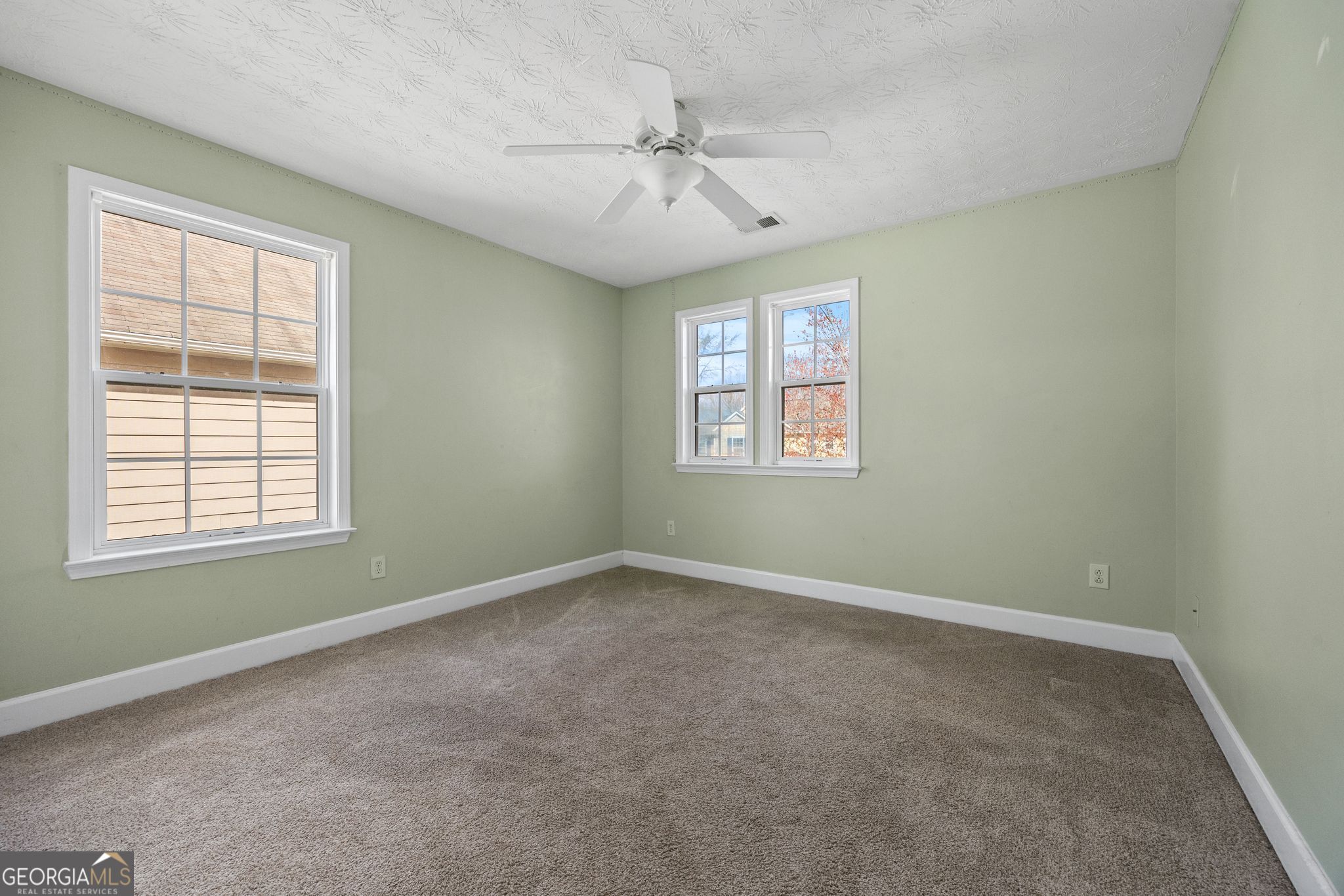 35 Timber Lane Newnan, GA 30265 - Photo 39 of 51 an empty room with a window and a ceiling fan