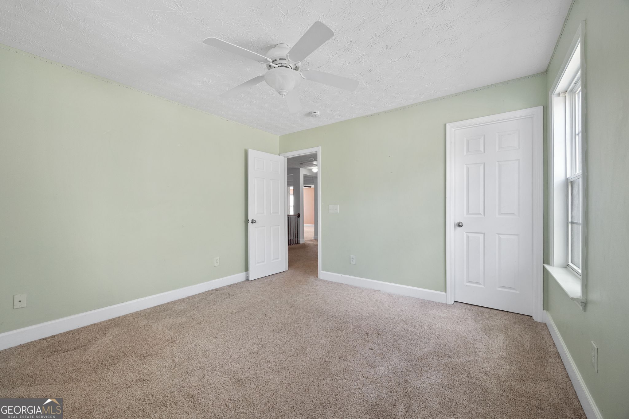 35 Timber Lane Newnan, GA 30265 - Photo 40 of 51 an empty room with a ceiling fan and a window