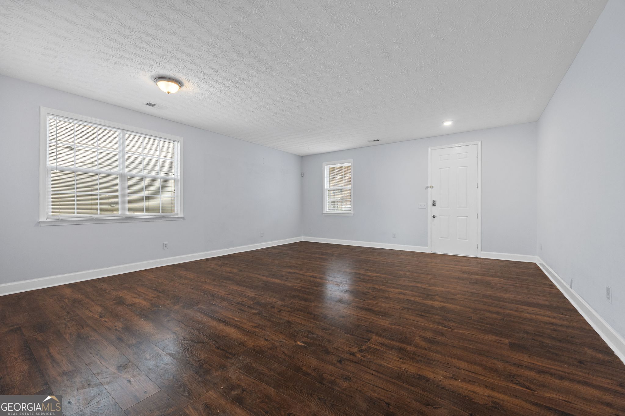 35 Timber Lane Newnan, GA 30265 - Photo 7 of 51 an empty room with wooden floor and windows