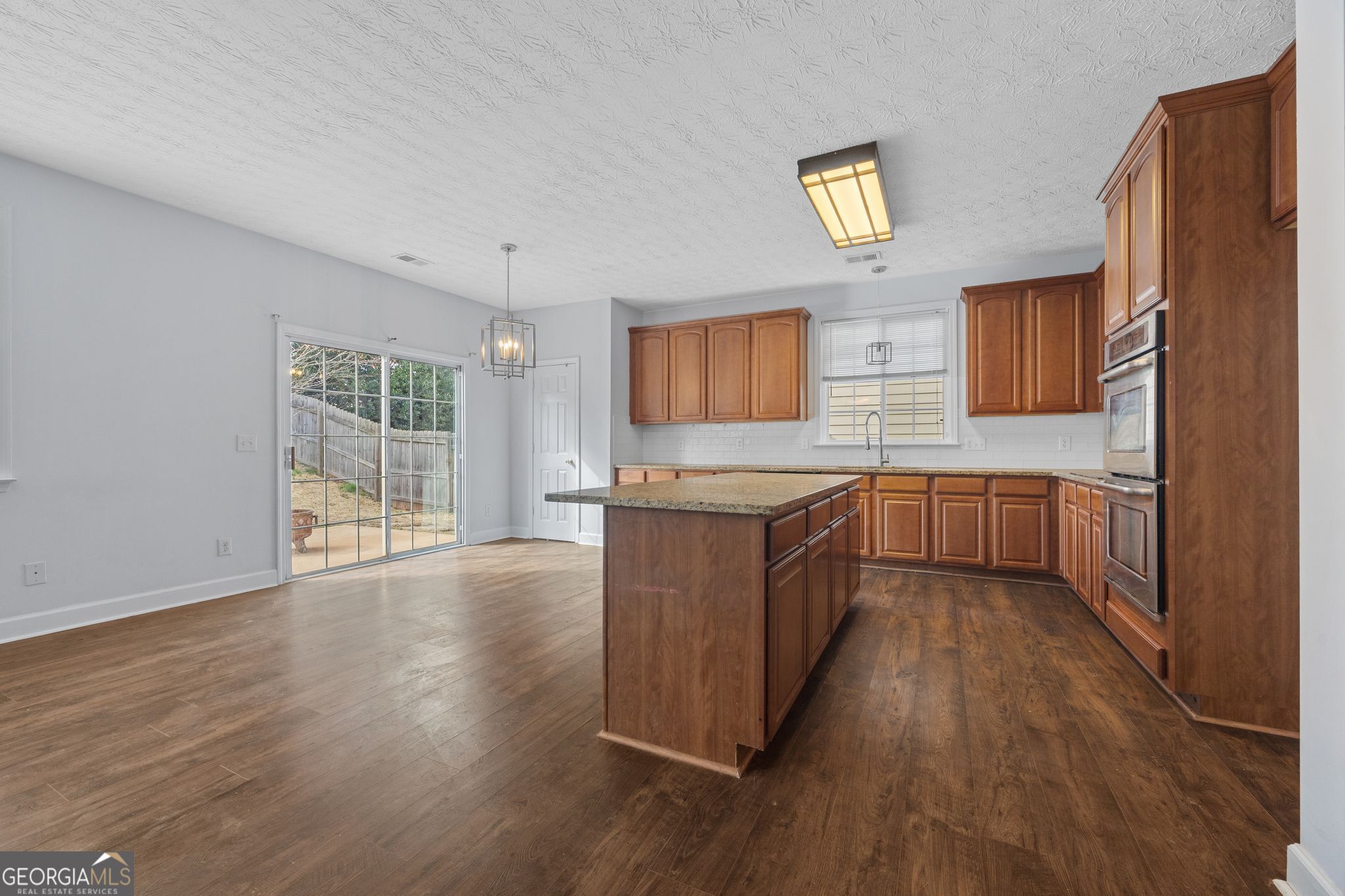 35 Timber Lane Newnan, GA 30265 - Photo 10 of 51 a large kitchen with a wooden floor and a sink