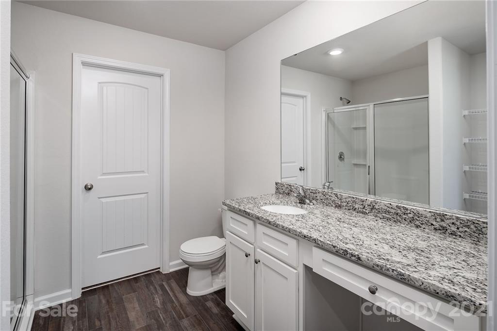 281 Rosedale Street Kings Mountain, NC 28086 - Photo 14 of 19 a bathroom with a granite countertop sink a toilet and a shower