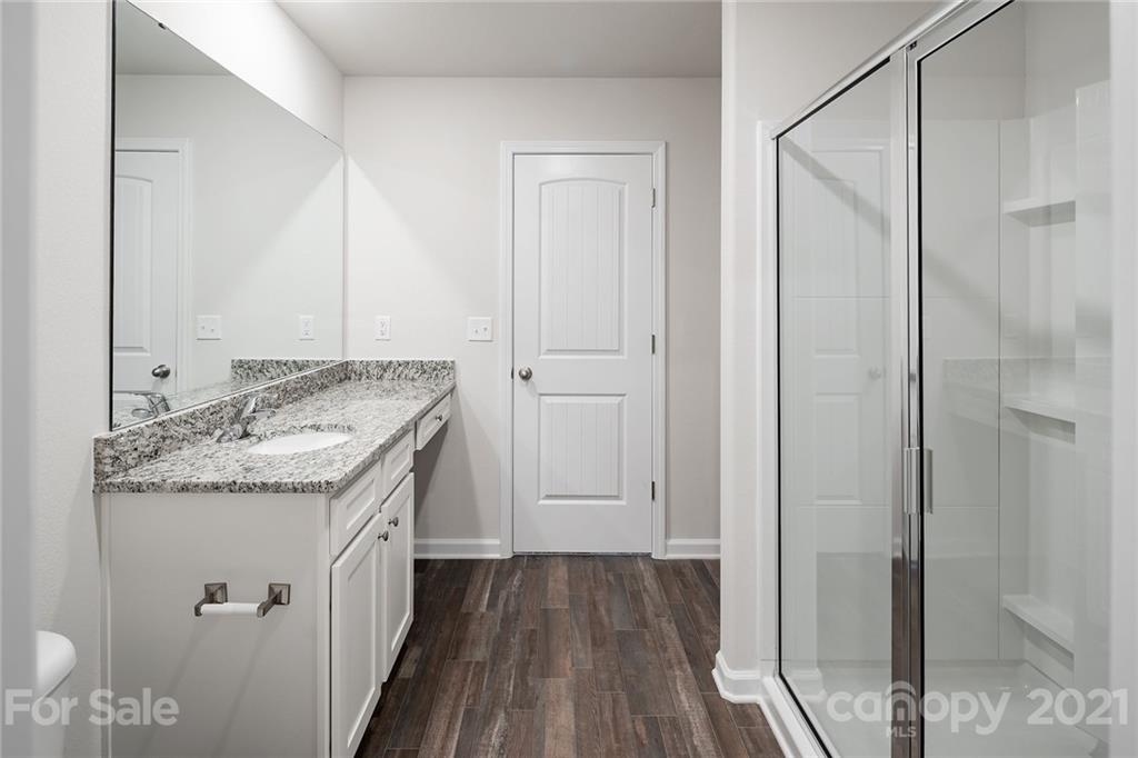 281 Rosedale Street Kings Mountain, NC 28086 - Photo 16 of 19 a bathroom with a granite countertop sink a mirror and shower