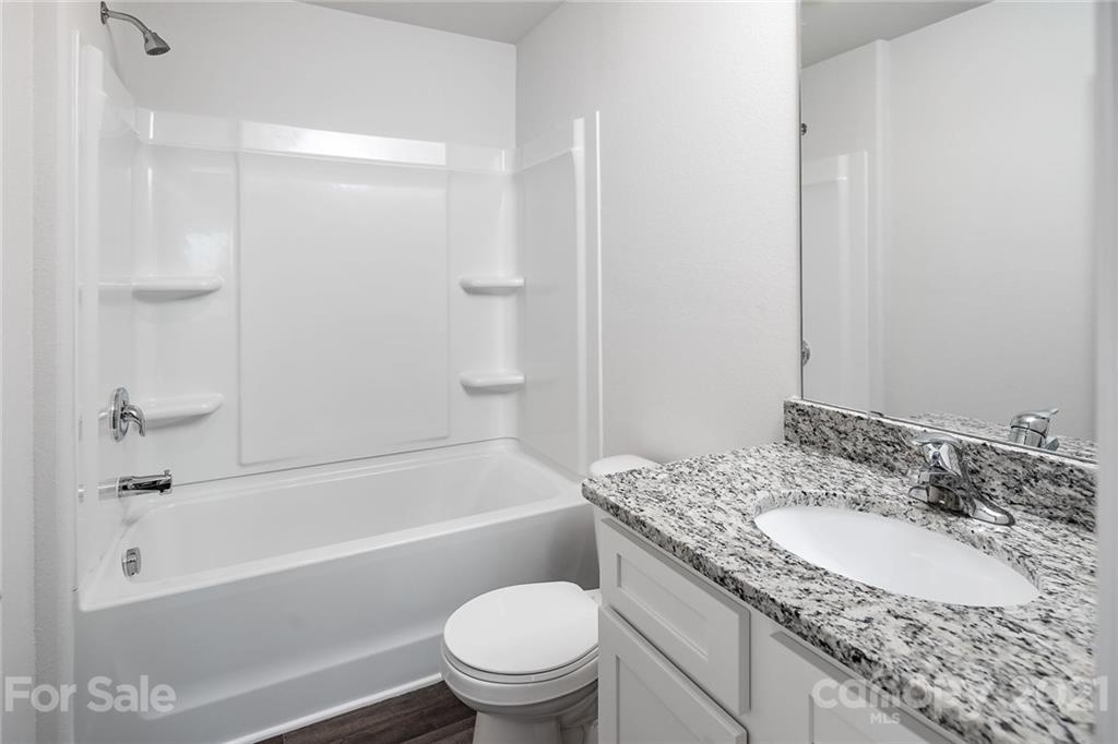 281 Rosedale Street Kings Mountain, NC 28086 - Photo 19 of 19 a bathroom with a granite countertop toilet a sink and a bathtub