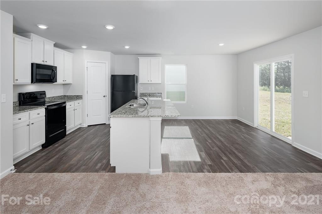 281 Rosedale Street Kings Mountain, NC 28086 - Photo 6 of 19 a open kitchen with kitchen island a sink dishwasher stove and oven with wooden floor