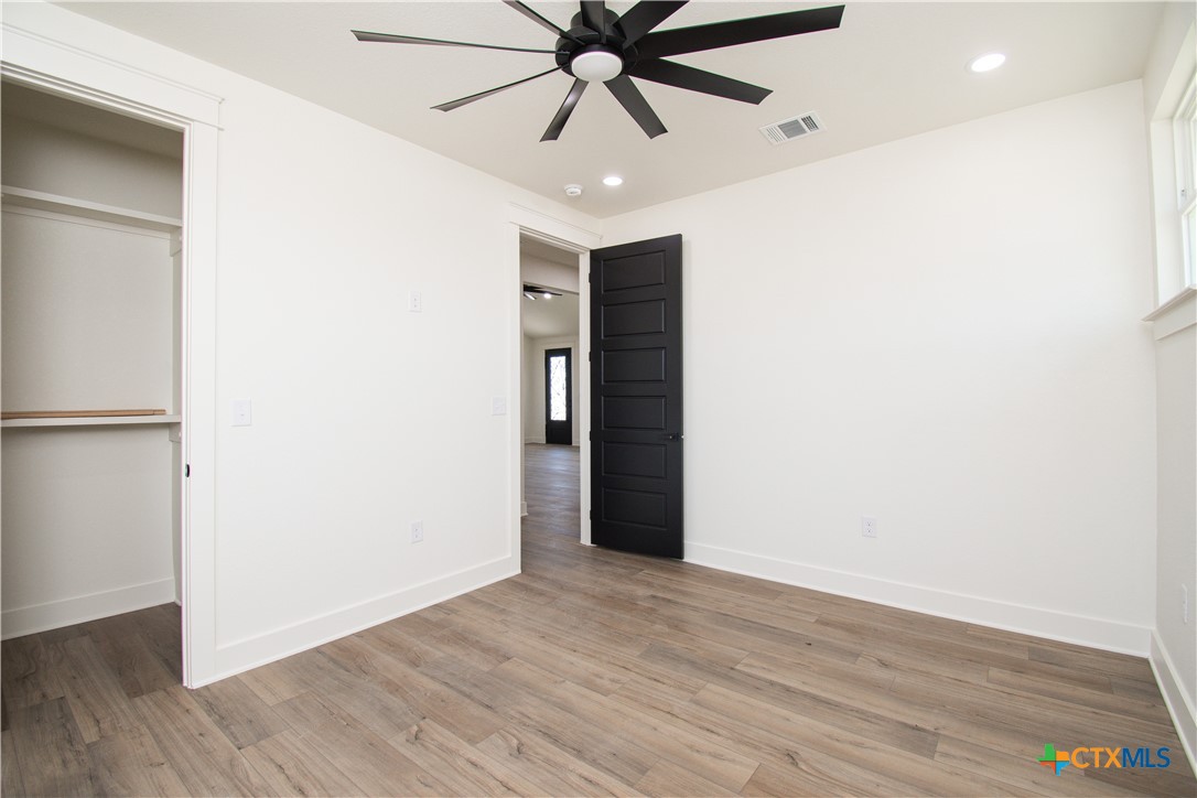 4245 Stringtown Road Temple, TX 76501 - Photo 18 of 25 a view of an empty room with wooden floor