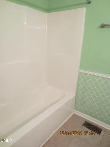 a bathroom with a bathtub and a window