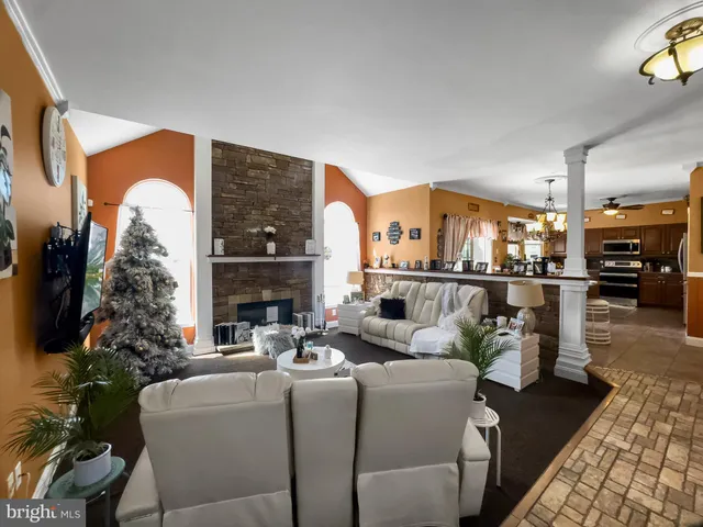 a kitchen with stainless steel appliances kitchen island granite countertop a refrigerator and cabinets