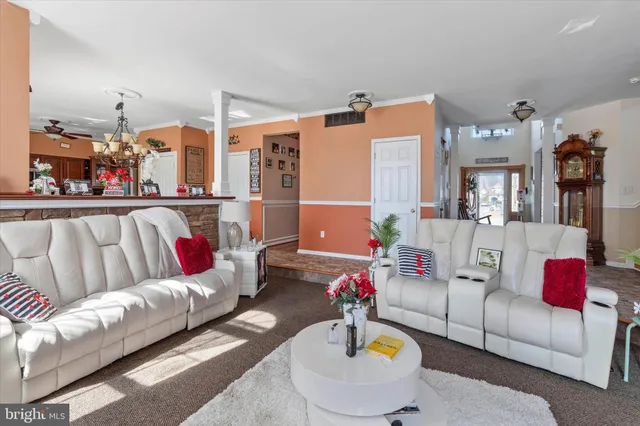 a dining room with furniture a window and a chandelier