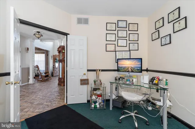 a bedroom with a bed and a flat tv screen on dresser