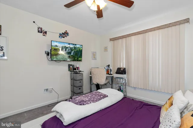an aerial view of a swimming pool with a yard and outdoor seating