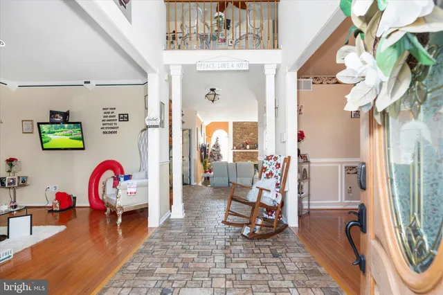 a living room with furniture a fireplace and potted plants