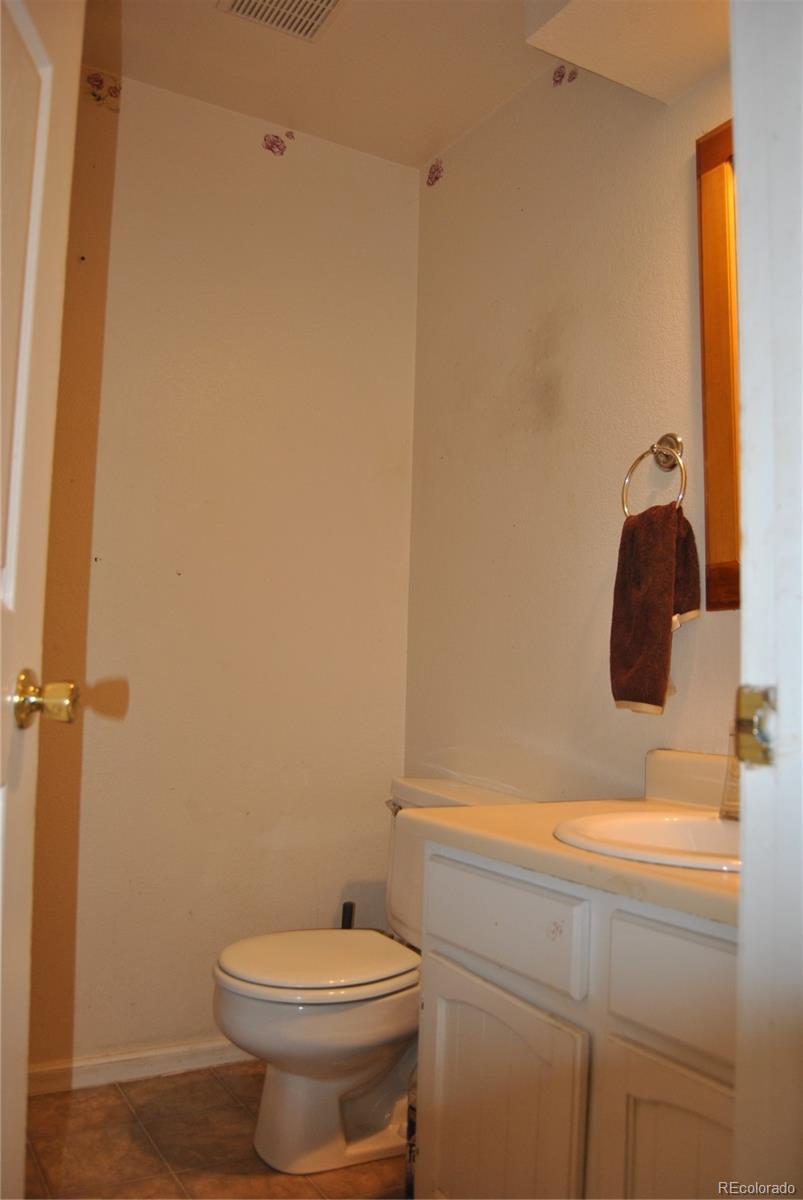 1904 Eagle Street Aurora, CO 80011 - Photo 11 of 27 a bathroom with a sink and a toilet