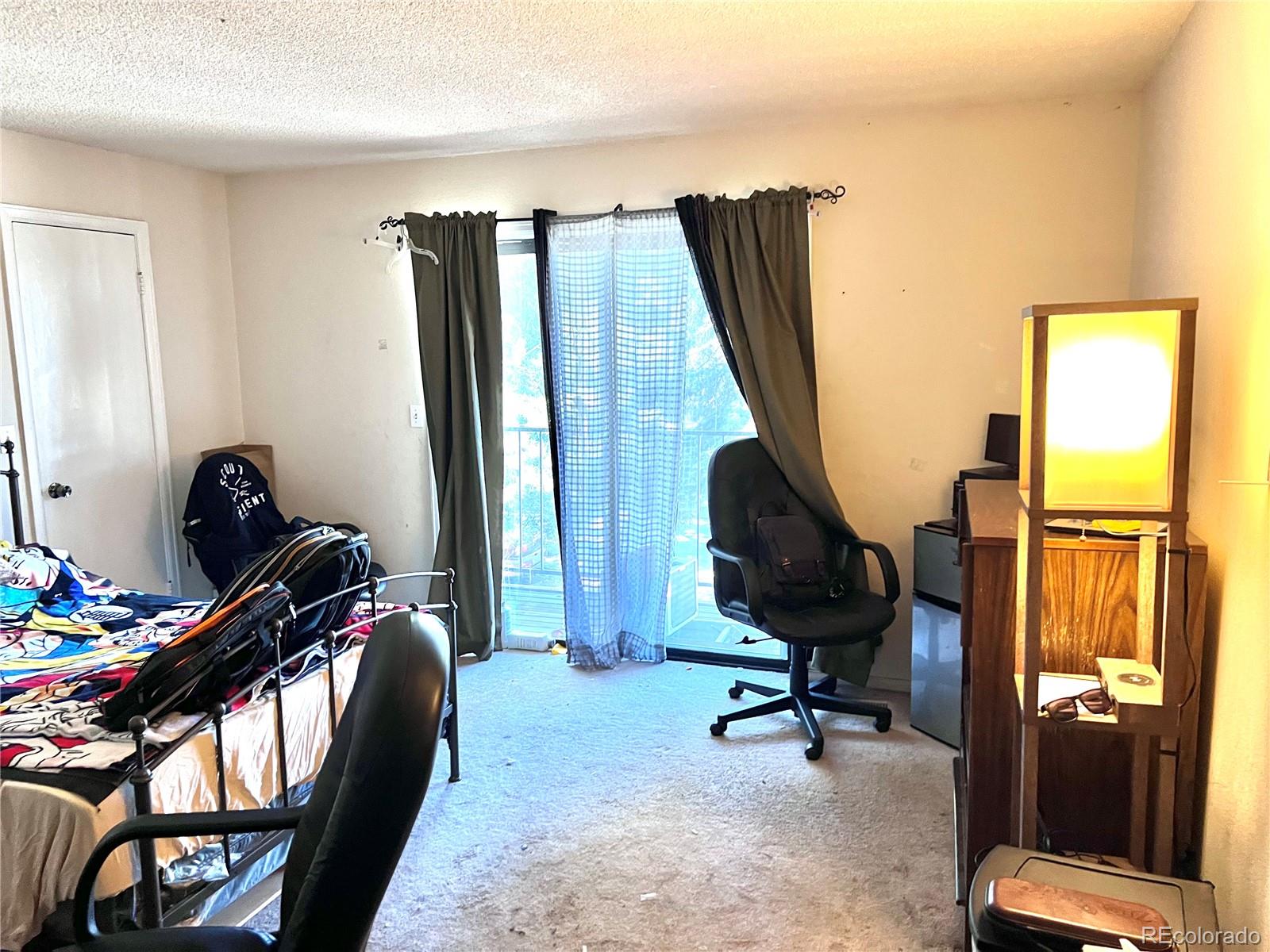 1904 Eagle Street Aurora, CO 80011 - Photo 12 of 27 a view of a workspace with furniture and a window