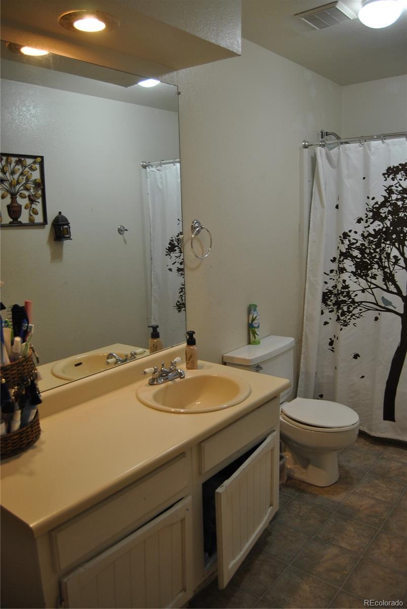 1904 Eagle Street Aurora, CO 80011 - Photo 14 of 27 a bathroom with a sink a toilet and shower