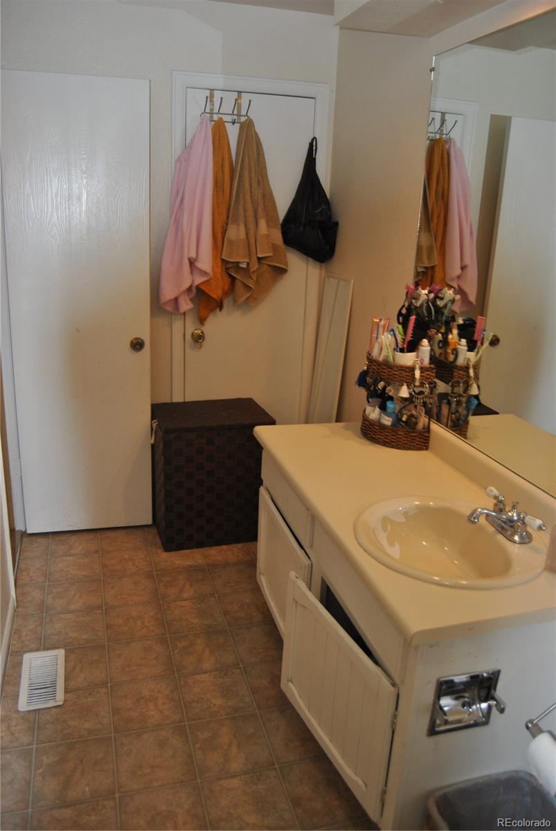1904 Eagle Street Aurora, CO 80011 - Photo 15 of 27 a bathroom with a sink and a mirror