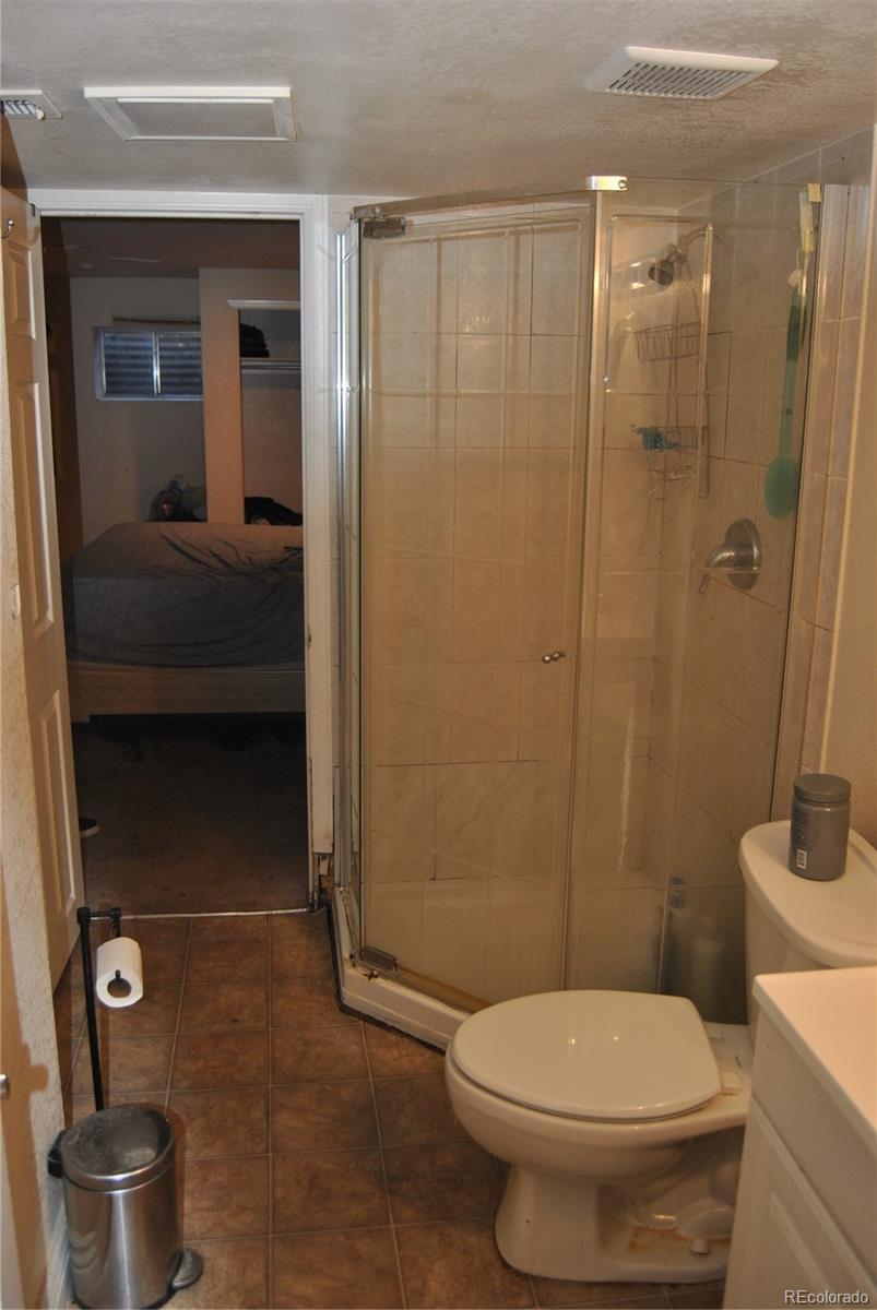 1904 Eagle Street Aurora, CO 80011 - Photo 17 of 27 a bathroom with a toilet and a shower