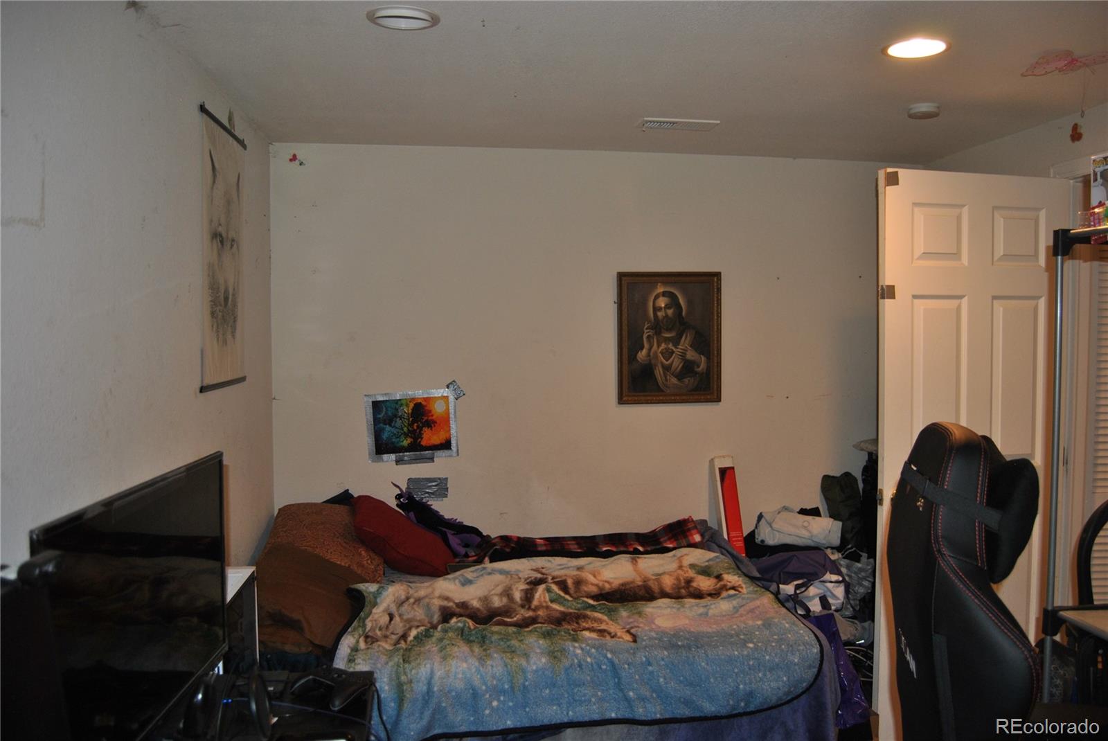 1904 Eagle Street Aurora, CO 80011 - Photo 18 of 27 a bedroom with furniture and a air conditioner vent