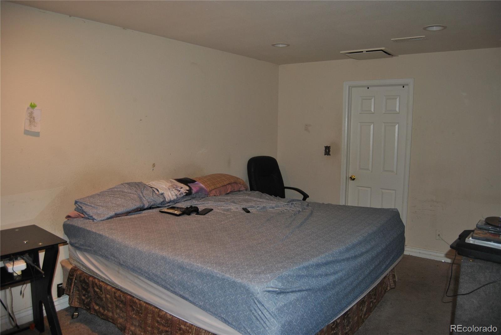 1904 Eagle Street Aurora, CO 80011 - Photo 19 of 27 a bedroom with a bed and wooden floor