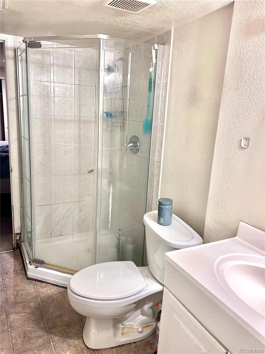 1904 Eagle Street Aurora, CO 80011 - Photo 20 of 27 a bathroom with a toilet sink and shower