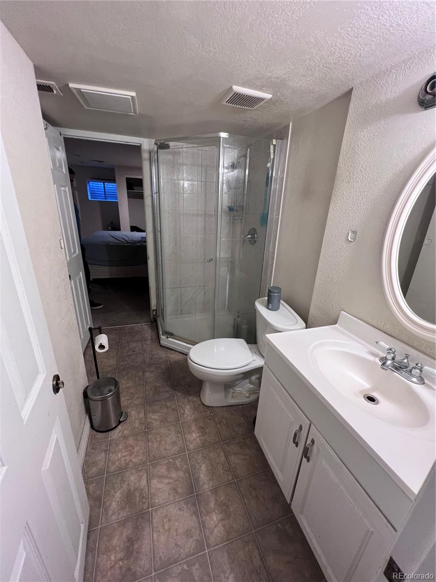 1904 Eagle Street Aurora, CO 80011 - Photo 22 of 27 a bathroom with a sink a toilet and shower