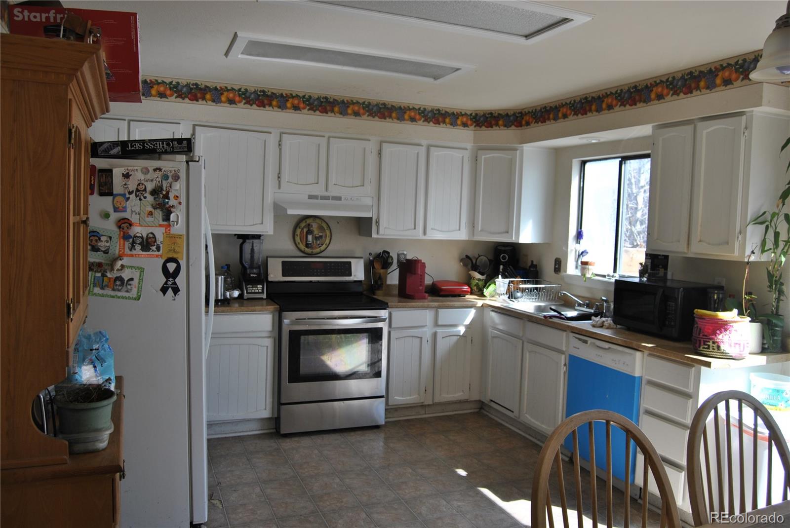 1904 Eagle Street Aurora, CO 80011 - Photo 3 of 27 a kitchen with stainless steel appliances granite countertop a refrigerator sink and stove