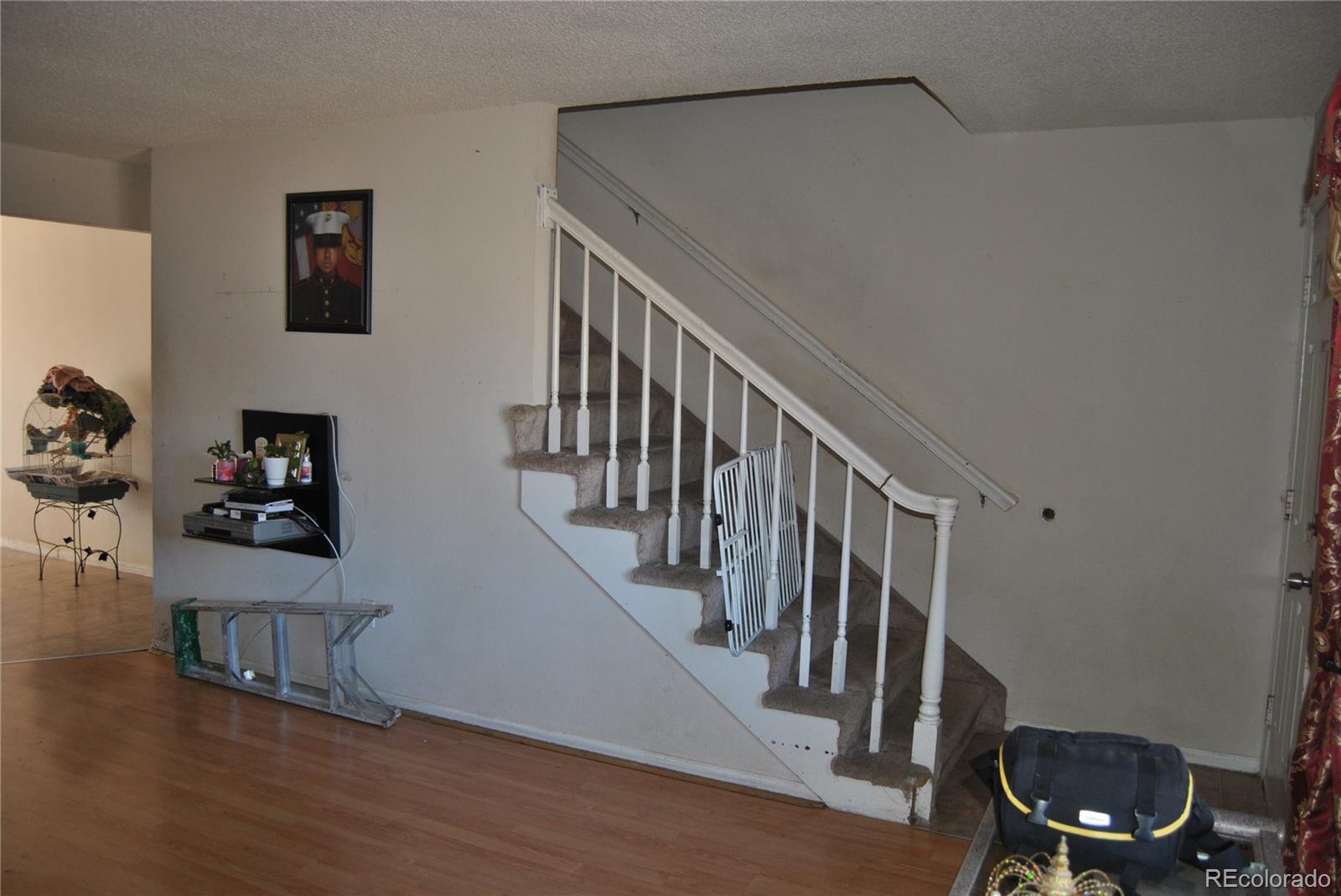 1904 Eagle Street Aurora, CO 80011 - Photo 8 of 27 a view of entryway and hall with wooden floor