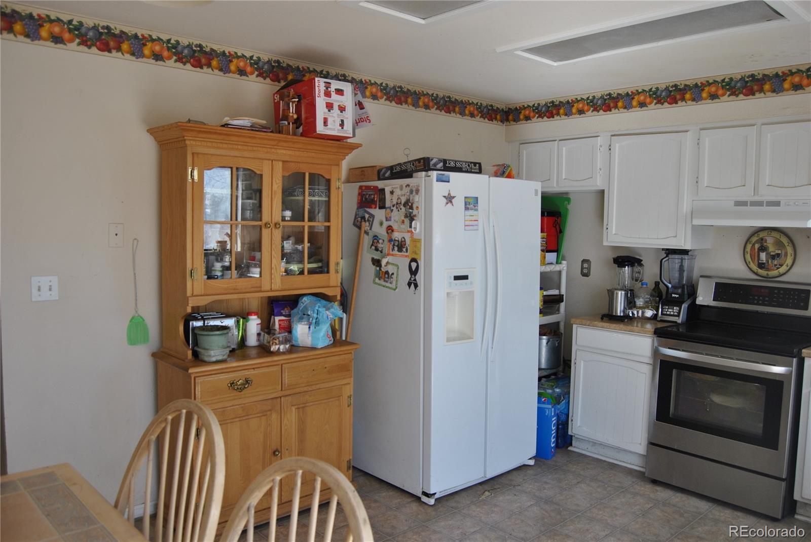 1904 Eagle Street Aurora, CO 80011 - Photo 9 of 27 a kitchen with stainless steel appliances a refrigerator and a stove top oven