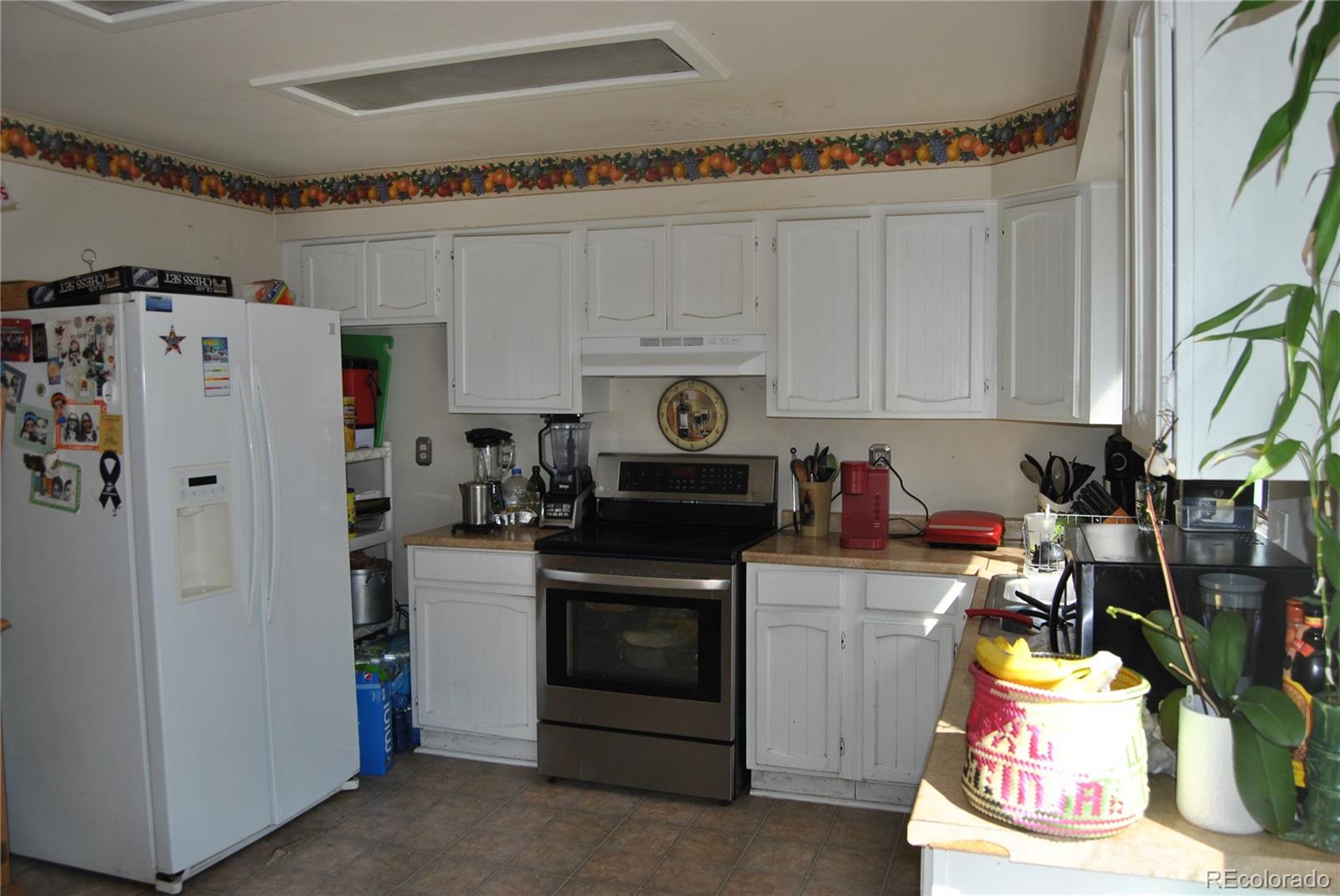 1904 Eagle Street Aurora, CO 80011 - Photo 10 of 27 a kitchen with stainless steel appliances granite countertop a refrigerator and a stove
