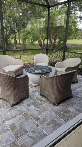 a view of a patio with couches chairs and a yard