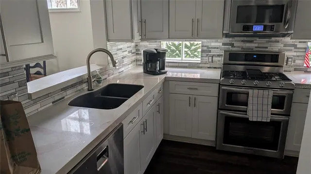 a kitchen with a sink and a stove top oven