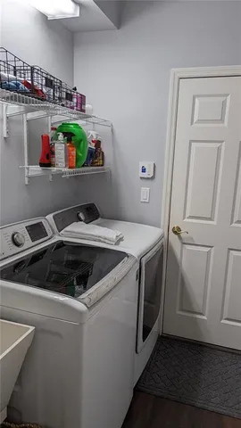 a kitchen with a stove and wooden floor