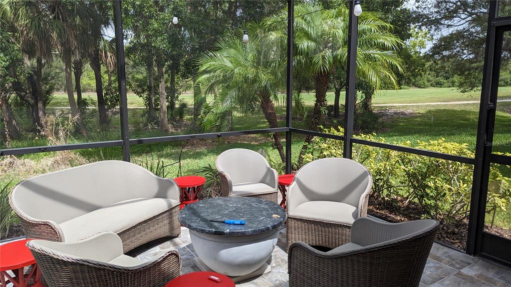 6264 Wingspan Way Bradenton, FL 34203 - Photo 20 of 27 a couple of white chairs sitting next to a yard next to a yard