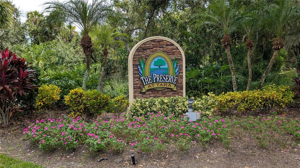 6264 Wingspan Way Bradenton, FL 34203 - Photo 27 of 27 a stone house with lots of trees