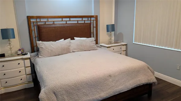 a bed sitting in a bedroom next to a window with dresser