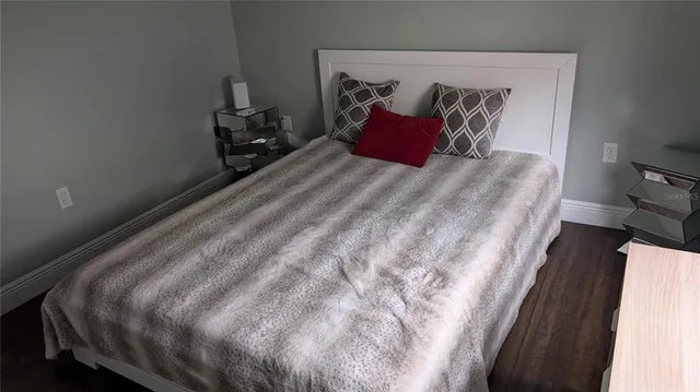 a large bed sitting in a bedroom next to a wooden floor