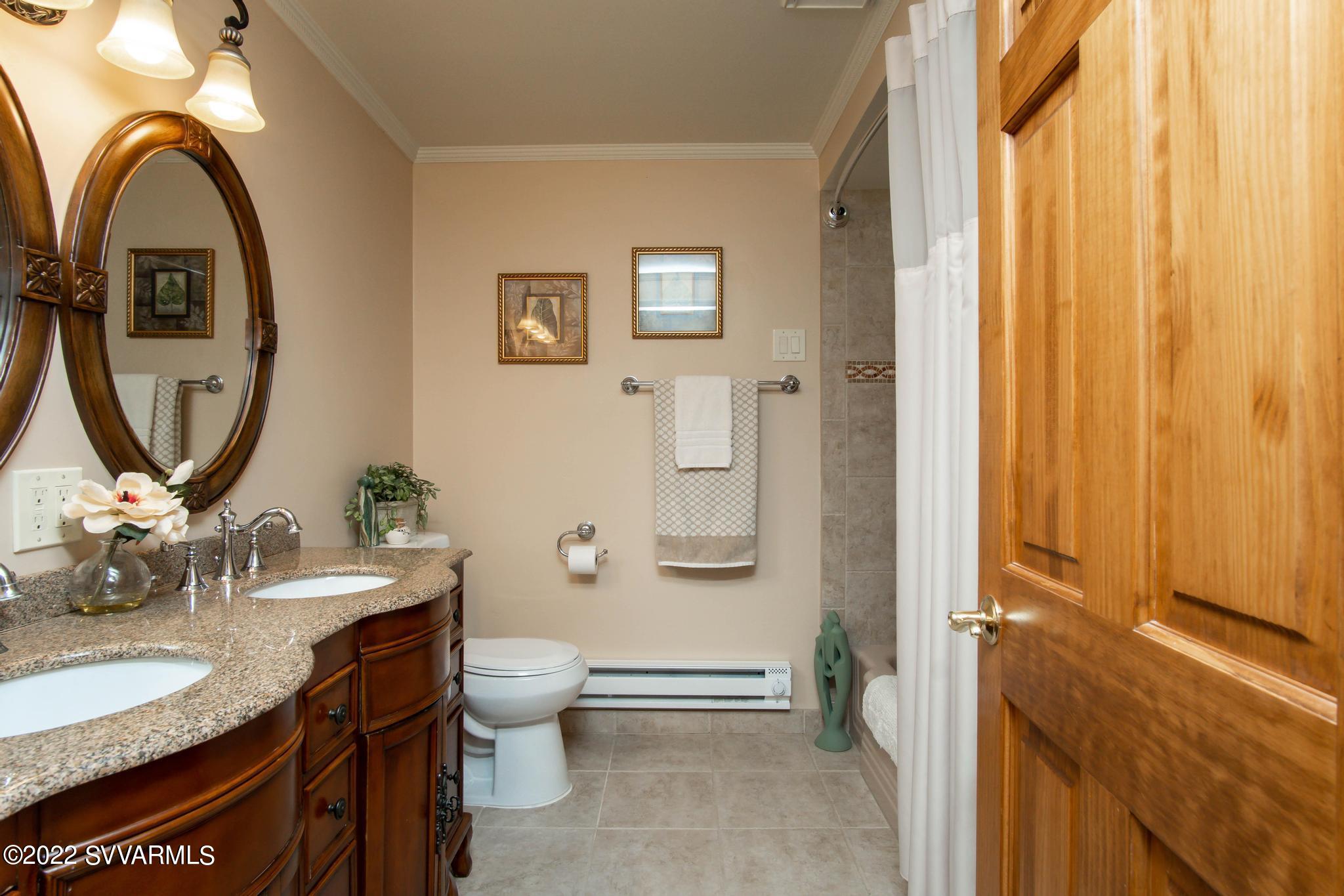 3685 East Rimrock Drive Rimrock, AZ 86335 - Photo 20 of 47 a bathroom with a granite countertop toilet a sink and a mirror
