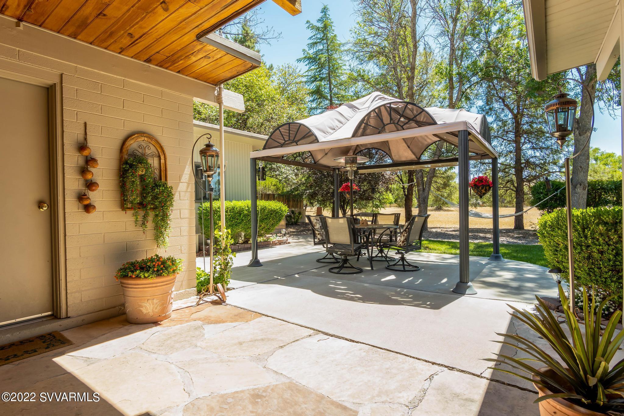 3685 East Rimrock Drive Rimrock, AZ 86335 - Photo 22 of 47 a view of a patio with a table and chairs under an umbrella