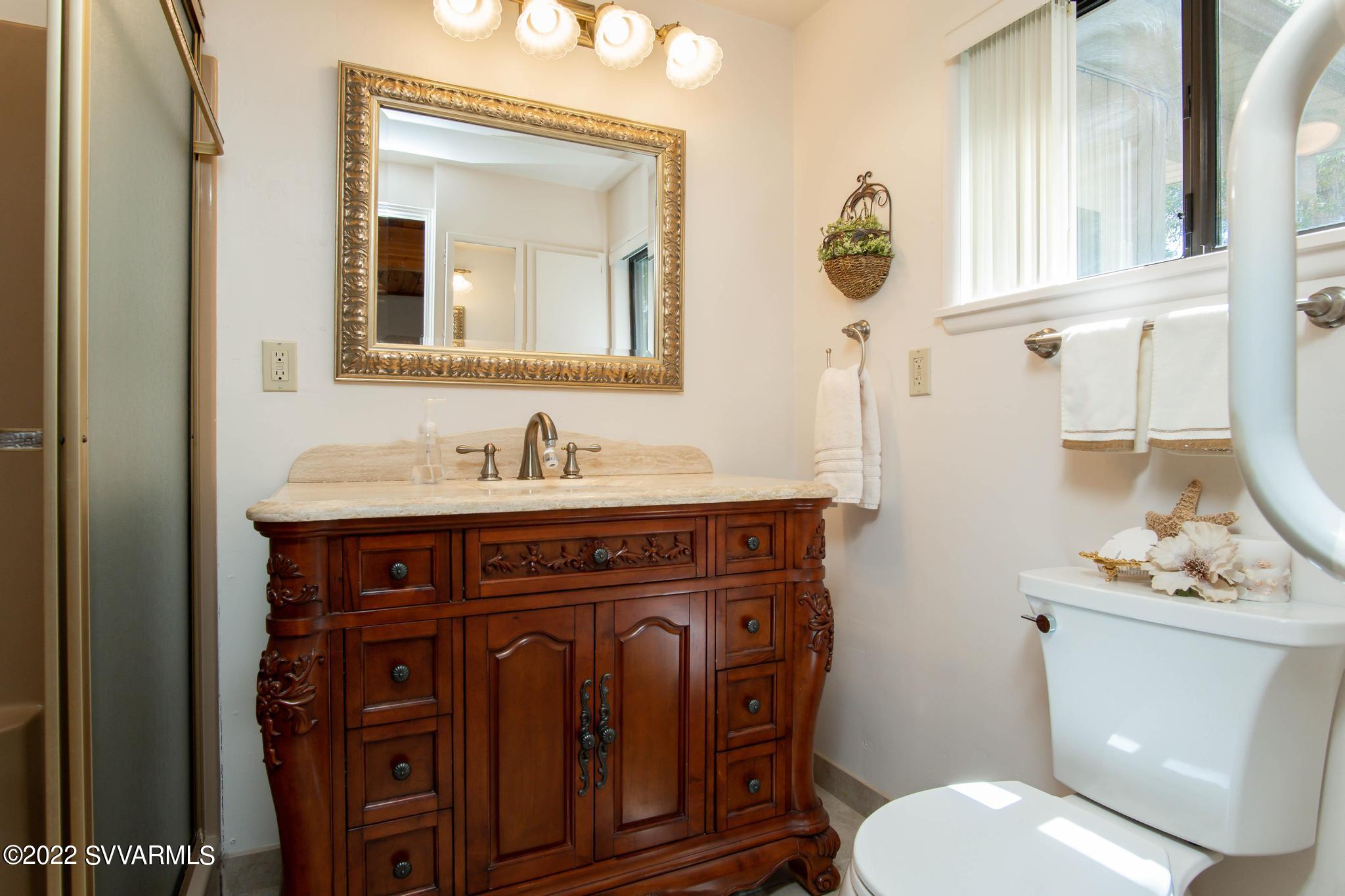 3685 East Rimrock Drive Rimrock, AZ 86335 - Photo 26 of 47 a bathroom with a toilet a sink and mirror
