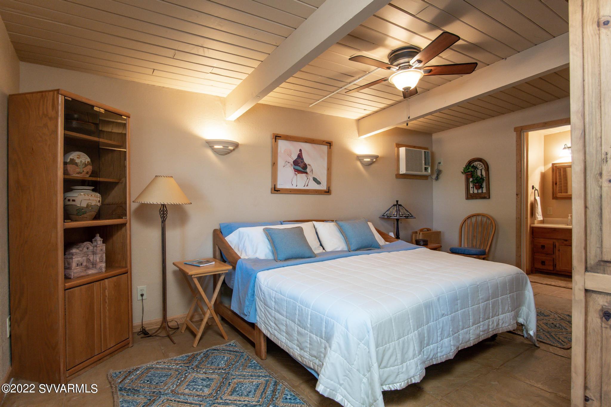 3685 East Rimrock Drive Rimrock, AZ 86335 - Photo 34 of 47 a bedroom with a bed and a chandelier