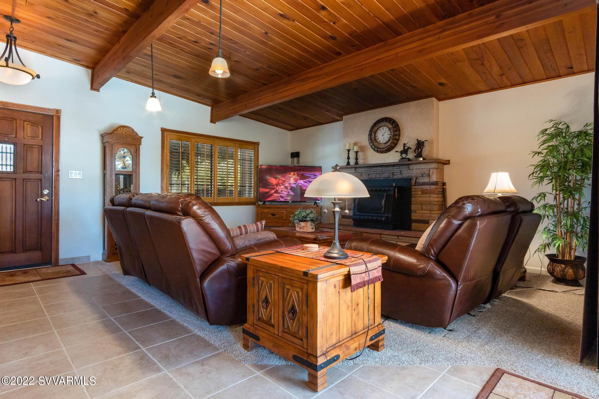 3685 East Rimrock Drive Rimrock, AZ 86335 - Photo 10 of 47 a living room with furniture a chandelier and a fireplace
