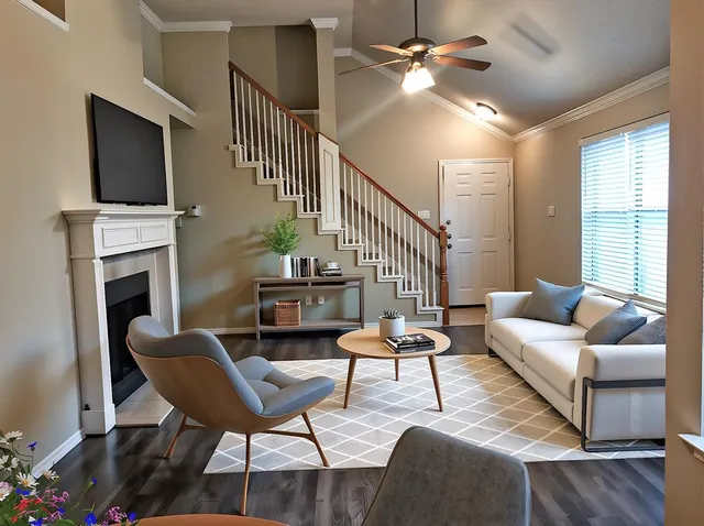 a living room with furniture a fireplace and a flat screen tv