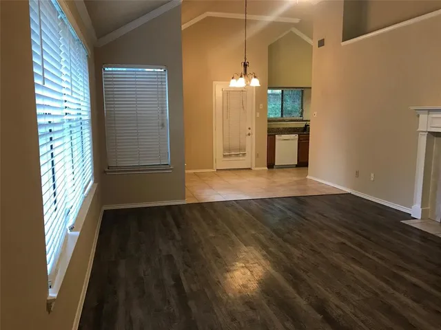a kitchen with a stove sink and cabinets