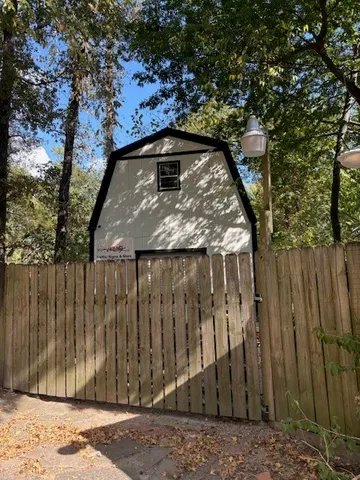 a view of backyard with wooden fence